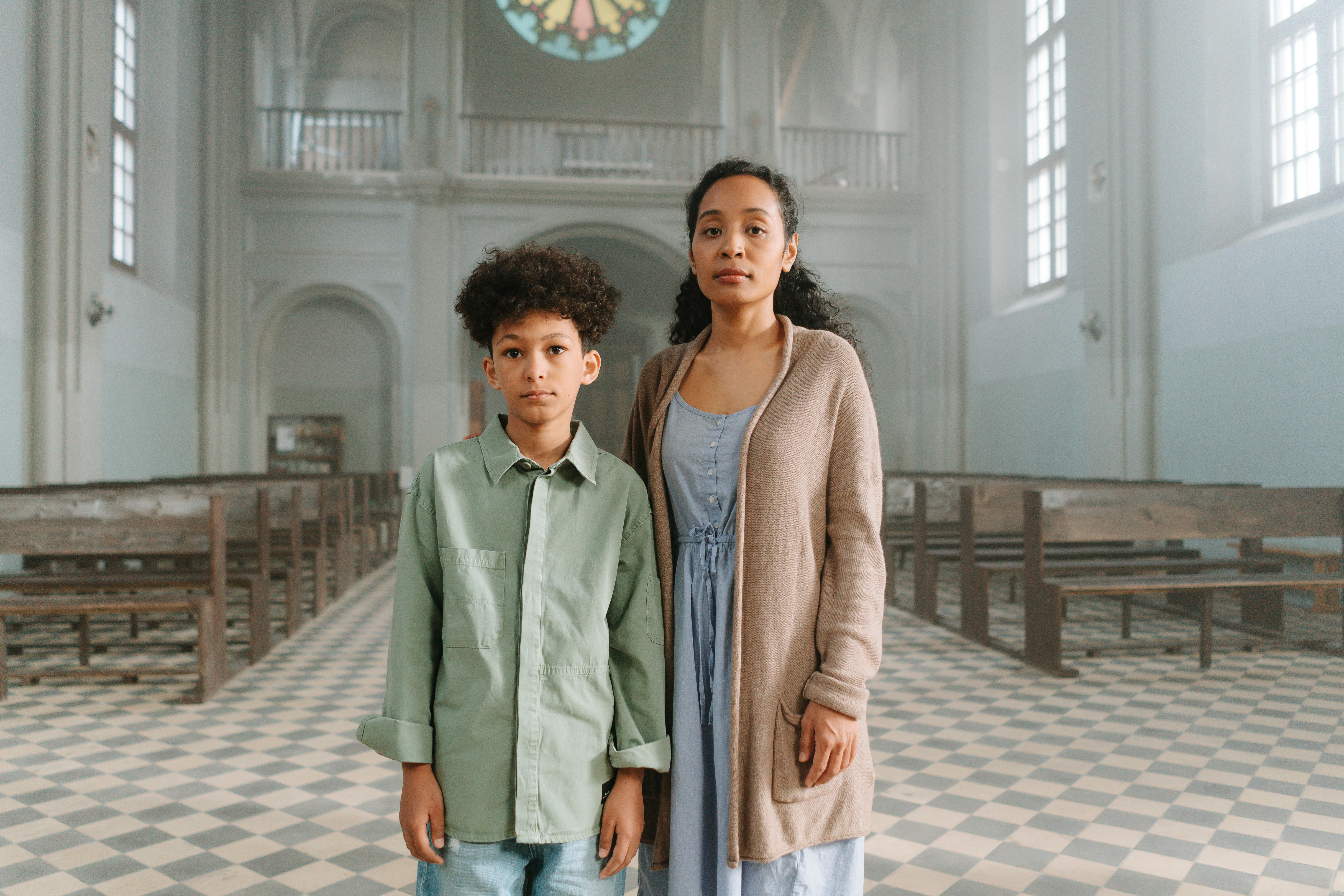 mother and son standing inside the church