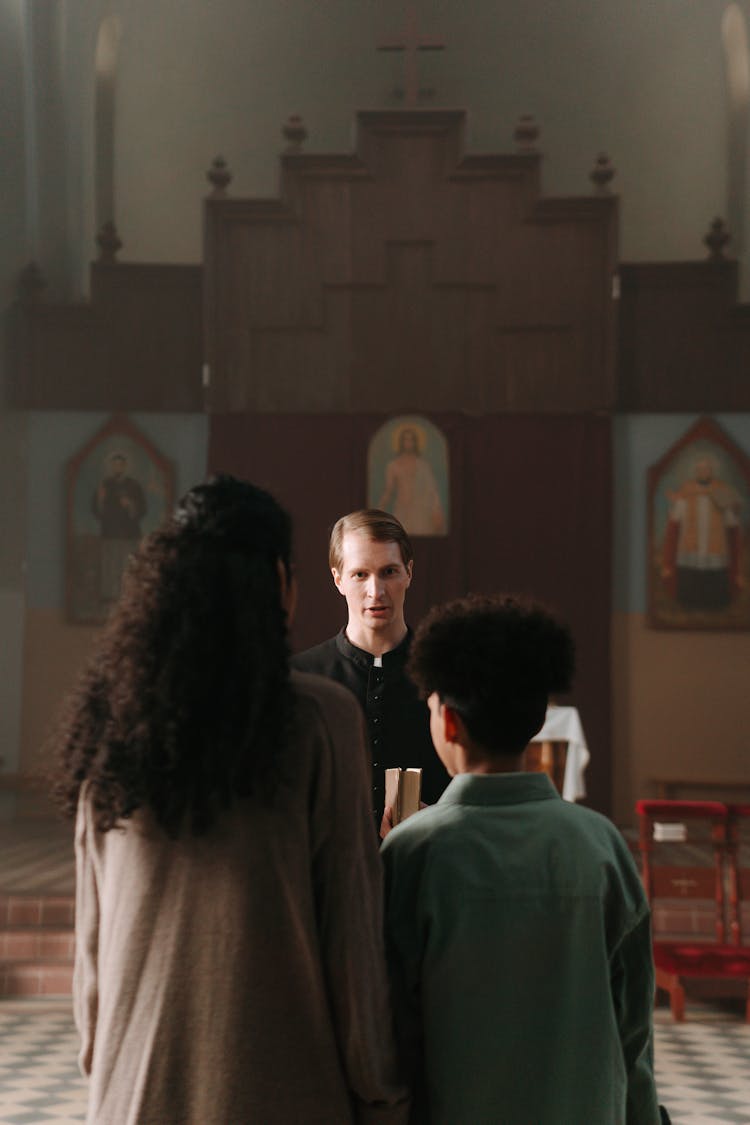 Priest Giving Sermon To Parishioners 