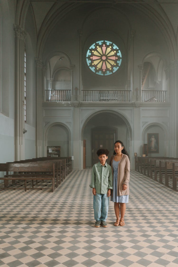 A Mother And Son Inside A Church