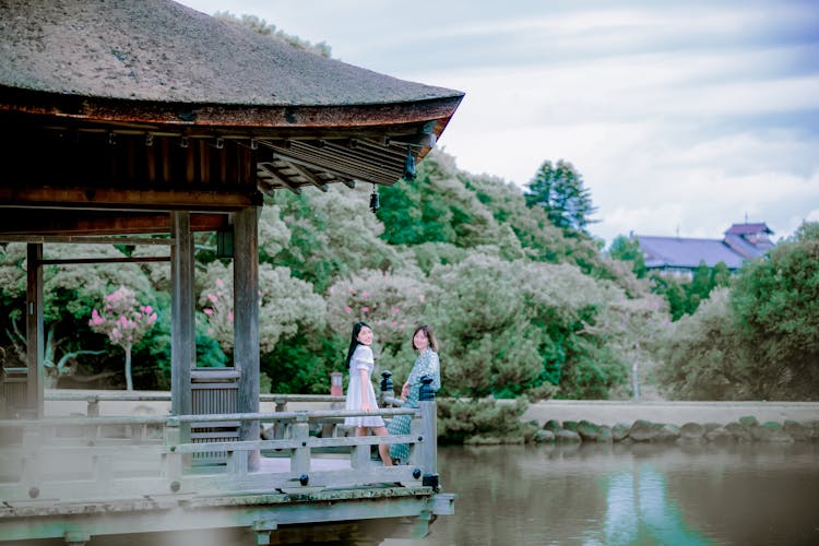 Women Smiling In Gazebo In Park