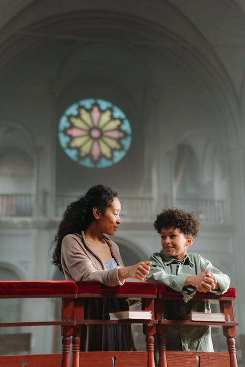 Free Mother and Child Kneeling in the Church Stock Photo