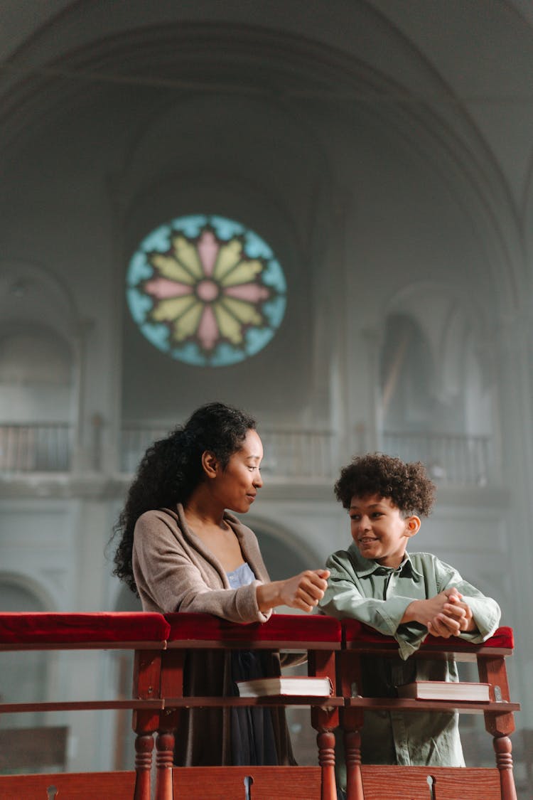 Mother And Child Kneeling In The Church