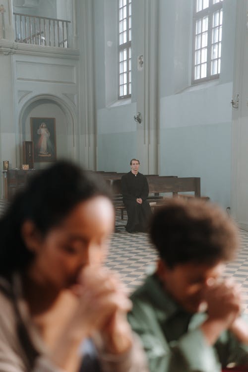 Free A Priest Sitting on the Wooden Bench Stock Photo
