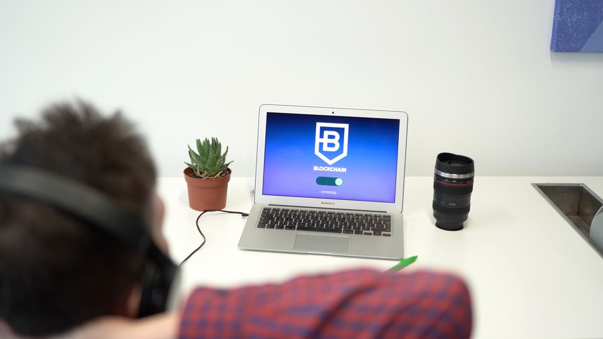 A laptop and notebook on a table ready for a step-by-step setup