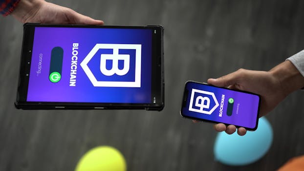 Smartphone and tablet displaying blockchain app interface, indicating tech connectivity.