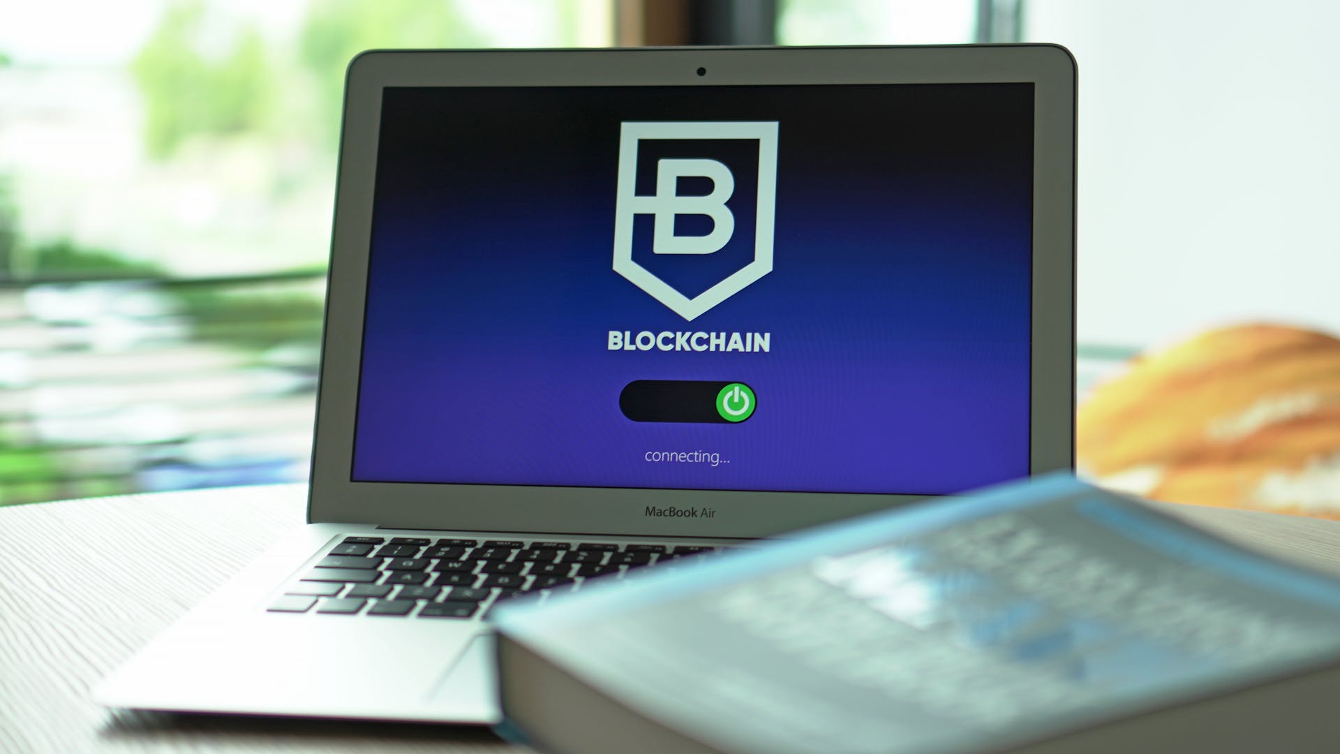 Laptop with blockchain application interface connecting. Ideal for tech and crypto themes.