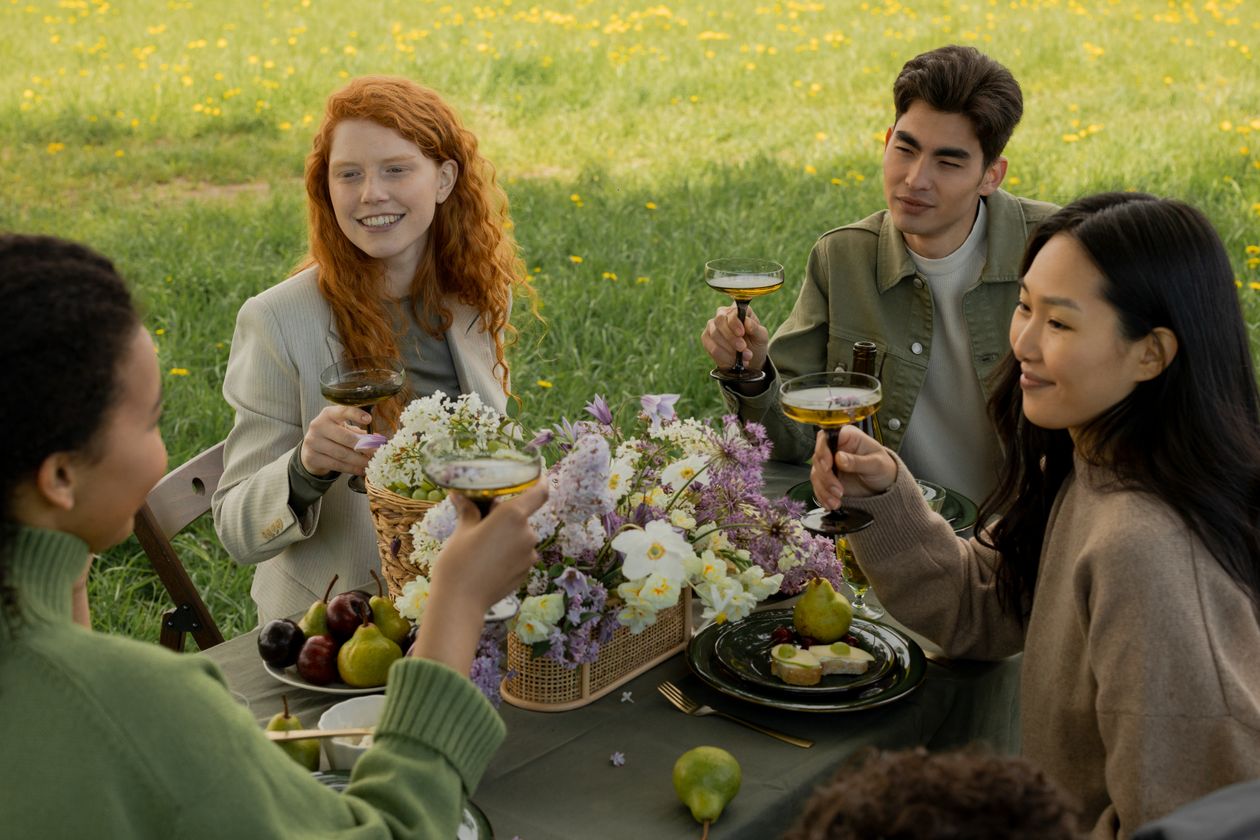 Group of friends tasting wine outdoors at the estate