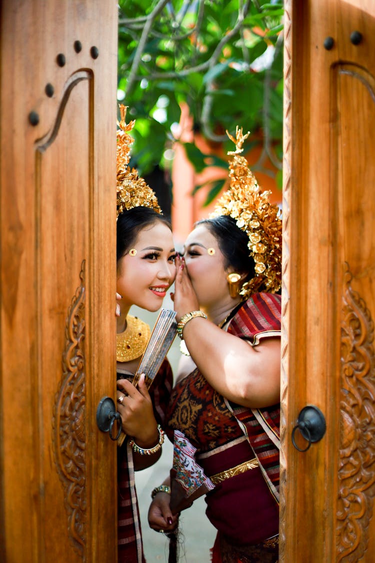 Woman In Red And Brown Dress Holding Brown Wooden Door