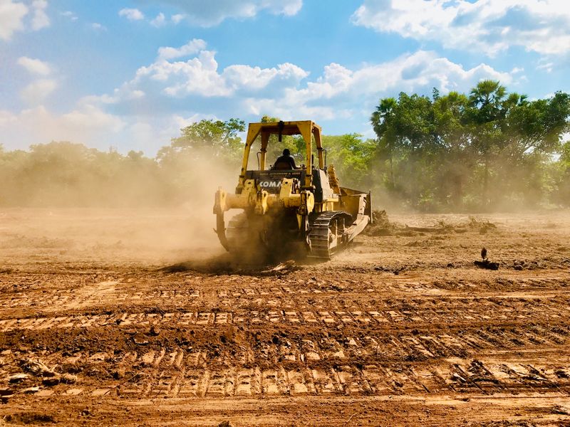 Land being cleared of vegetation and debris for a new site