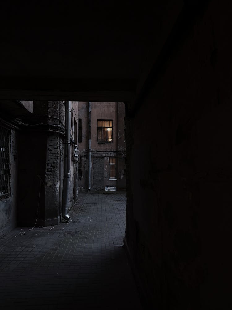 A View Of A Window From The Dark Alley