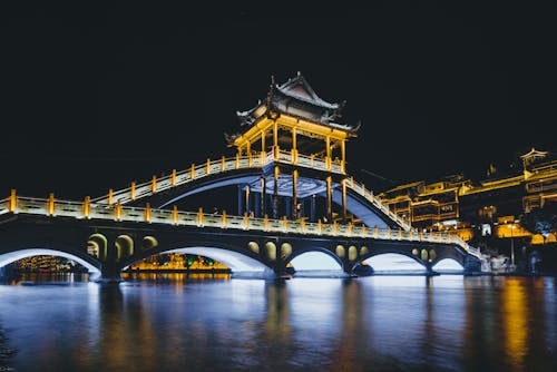 Illuminated Bridge over River 