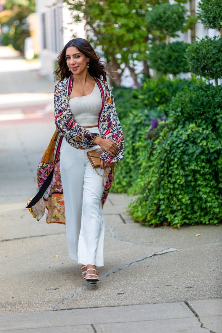 Woman Walking On Sidewalk