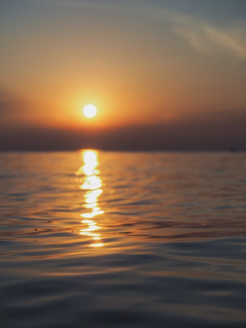 Reflection of the Sun on Water Surface During Sunset