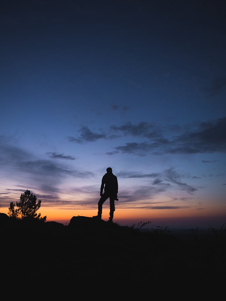 Silhouette Of A Person Standing On The Ground