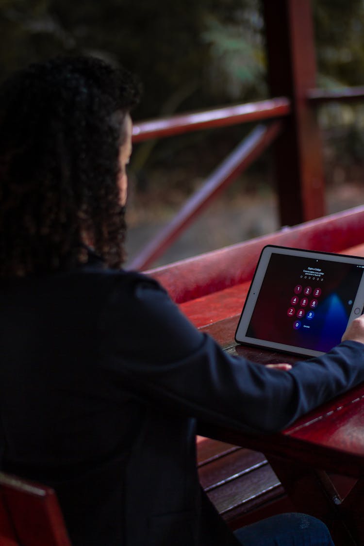 A Person Looking At A Tablet Screen With Password