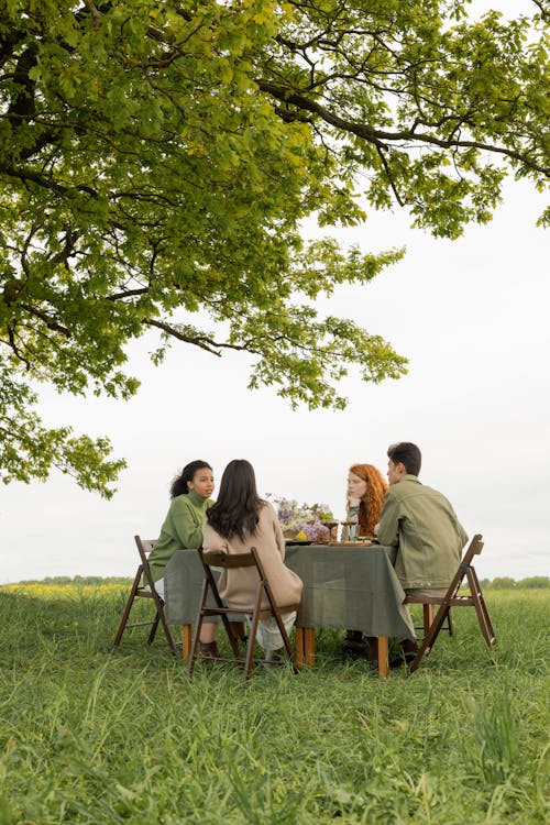Free  Group of Four Friends Sitting on a Table Talking Stock Photo