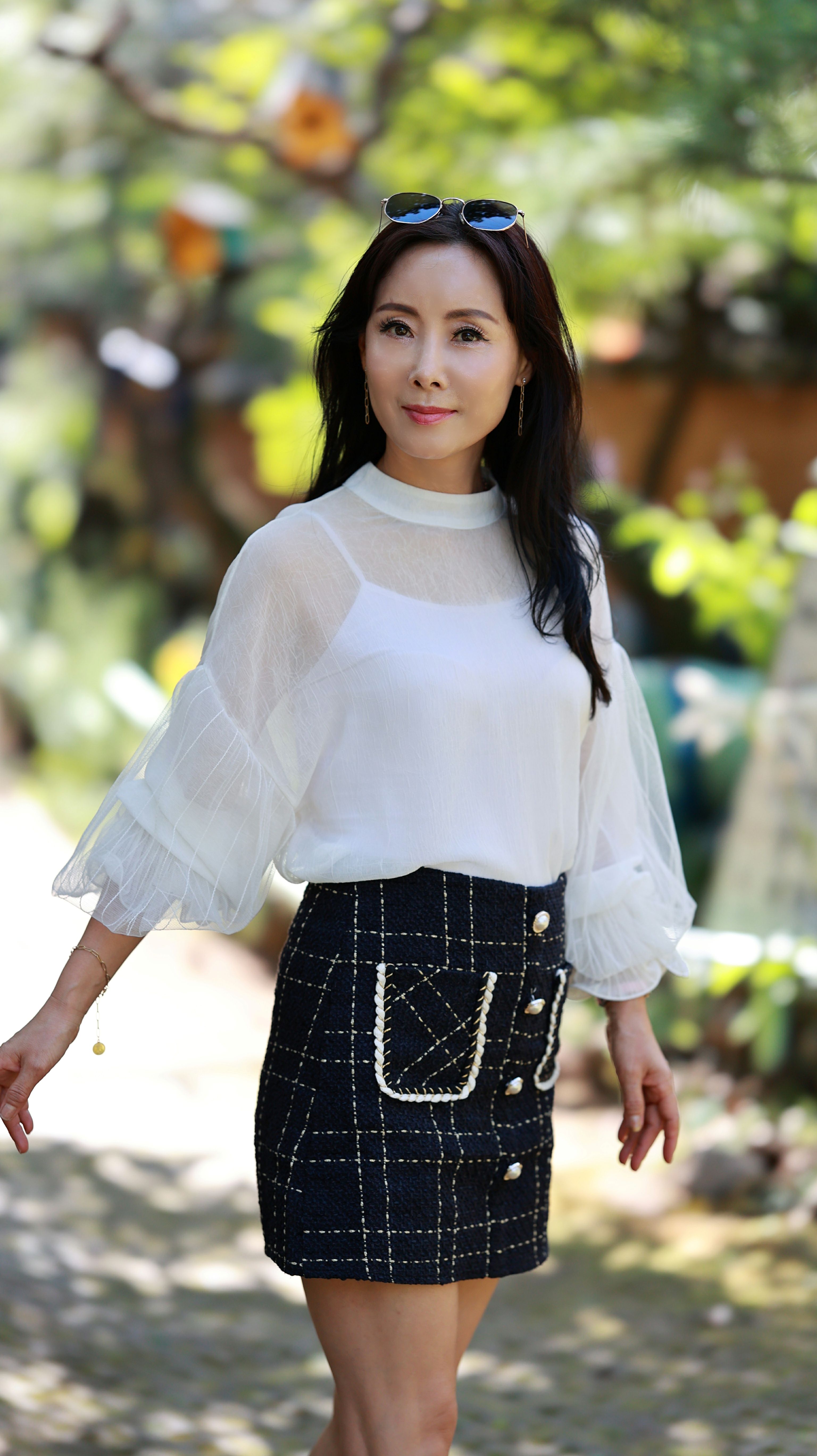 Woman in tweed mini skirt with white blouse