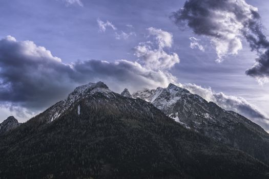 Dramatic cloud formation over the Watzmann peak in the Bavarian Alps during daylight.