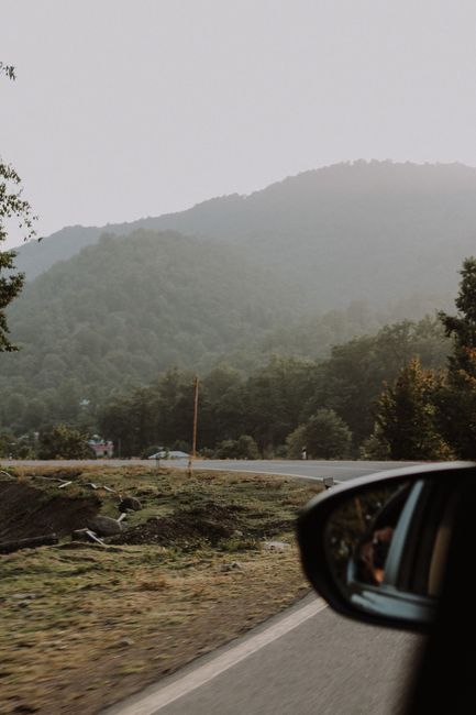 A serene view of a winding road through misty mountains in rural Лерик, Azerbaijan.