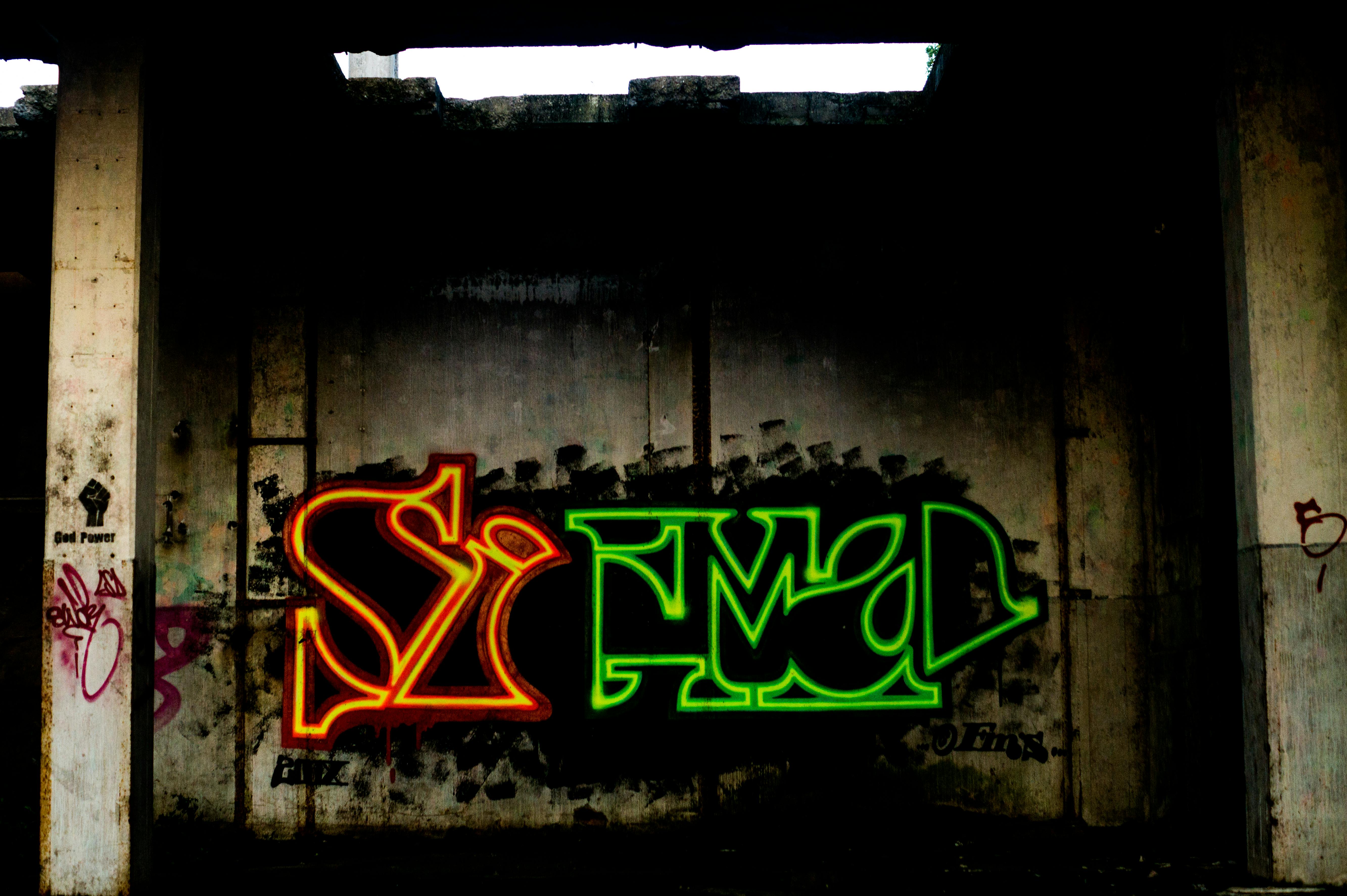 Dynamic street art featuring bold graffiti on an urban concrete wall, showcasing vibrant colors and creative expression.