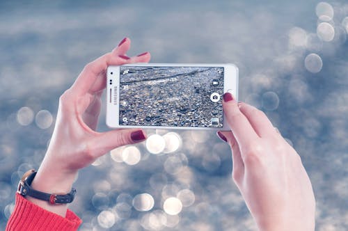 Free Selective Focus Photo of Person Holds White Samsung Galaxy Note Edge Stock Photo