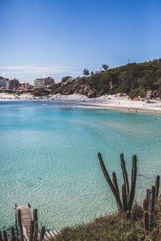 A serene beach scene with turquoise waters in Arraial do Cabo, Brazil.
