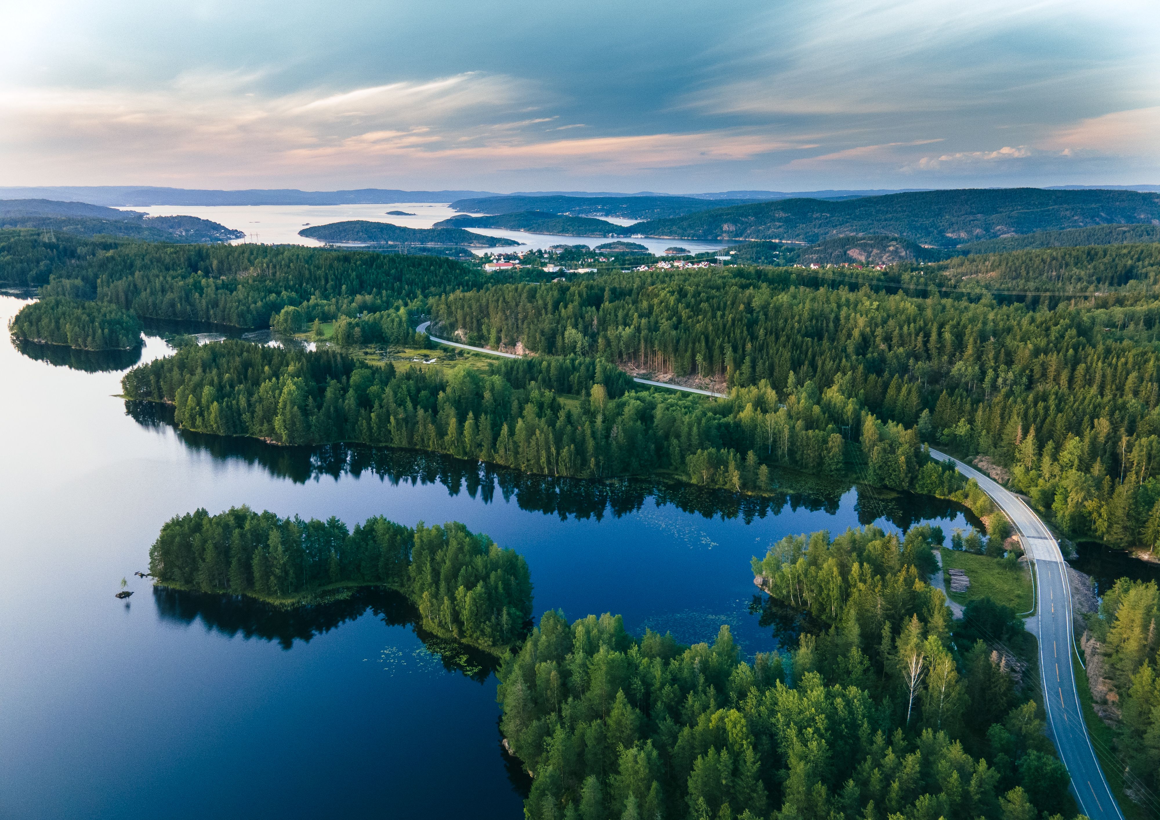 Breathtaking aerial view capturing lush forests and serene lakes in Viken, Norway.