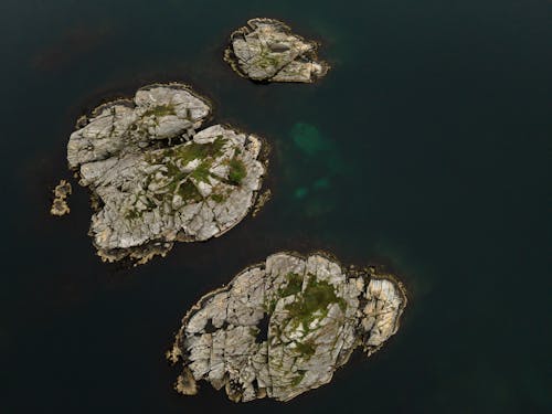 Gray Rock Formation on Body of Water
