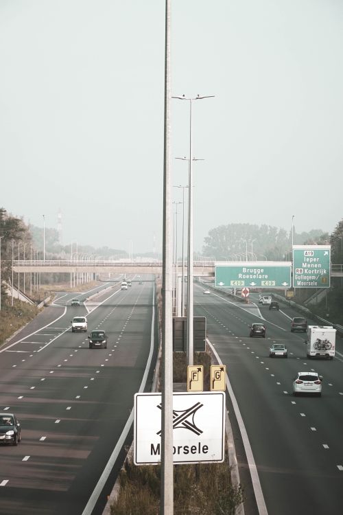 Free A bustling highway in Belgium showing vehicles, road signs, and an expansive view. Stock Photo