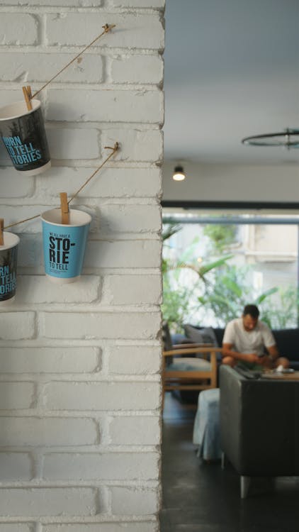 Hanging Paper Cups on White Wall · Free Stock Photo