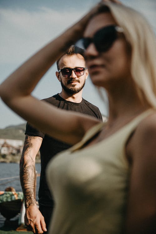 A Tattooed Man in Black Shirt Wearing Sunglasses