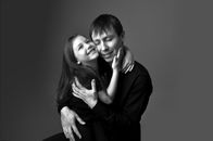 Grayscale Photo of Woman Hugging Woman