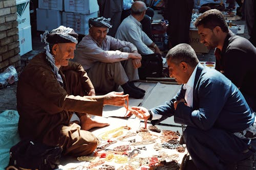 An Elderly Man Selling Bead Necklaces