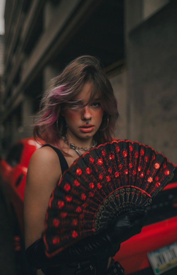 A Woman Holding A Fan