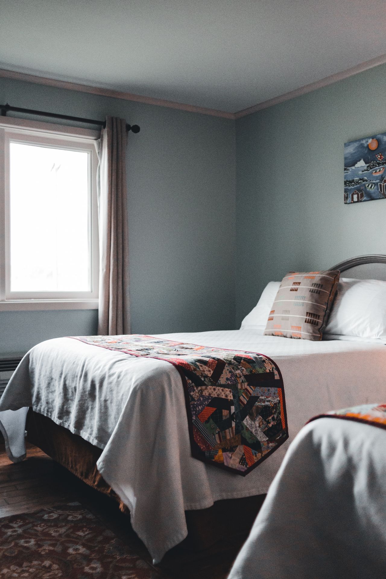 Twin beds dressed with colorful patchwork quilts