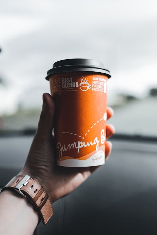 A Person Holding a Disposable Cup