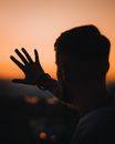 Man in White Shirt Raising His Right Hand