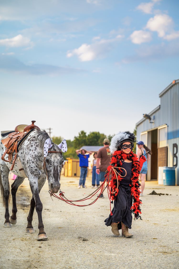 Woman In A Costume Leading A Horse 