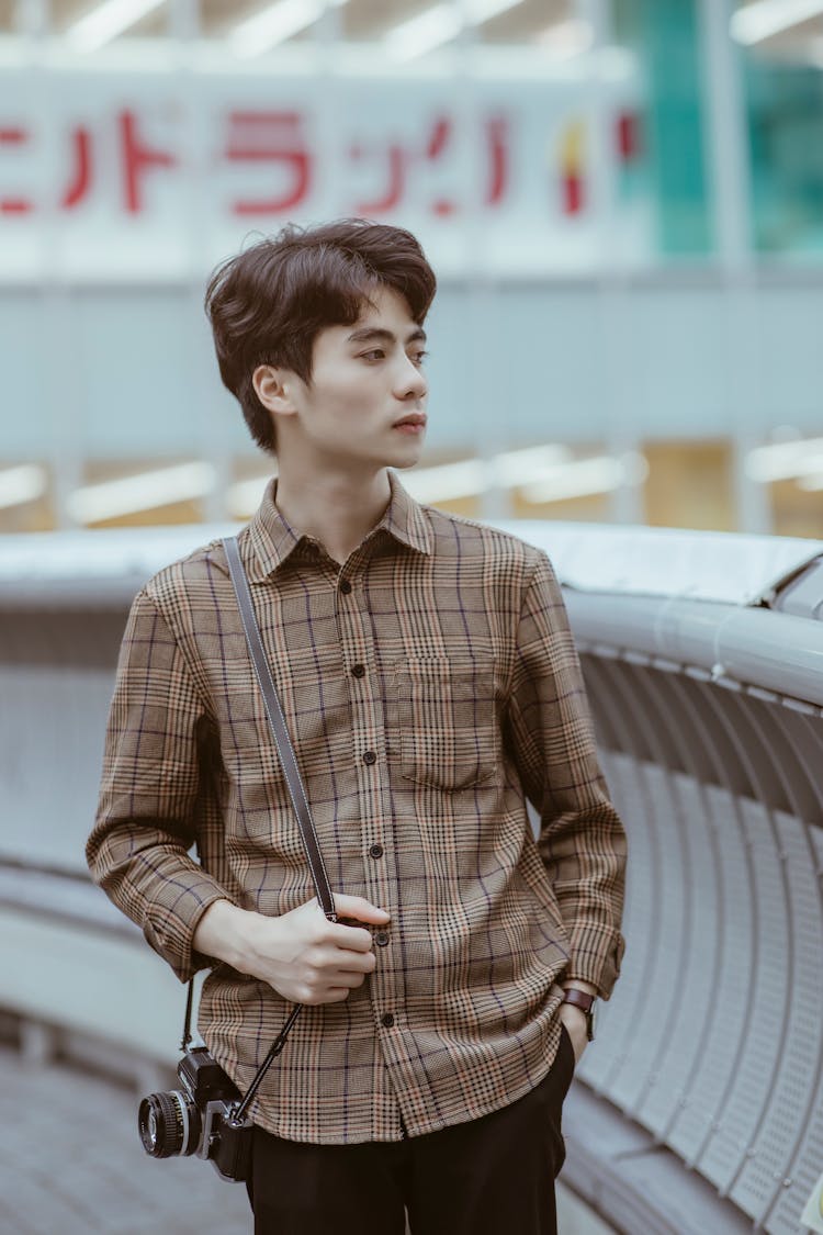 Young Man In A Checkered Shirt 