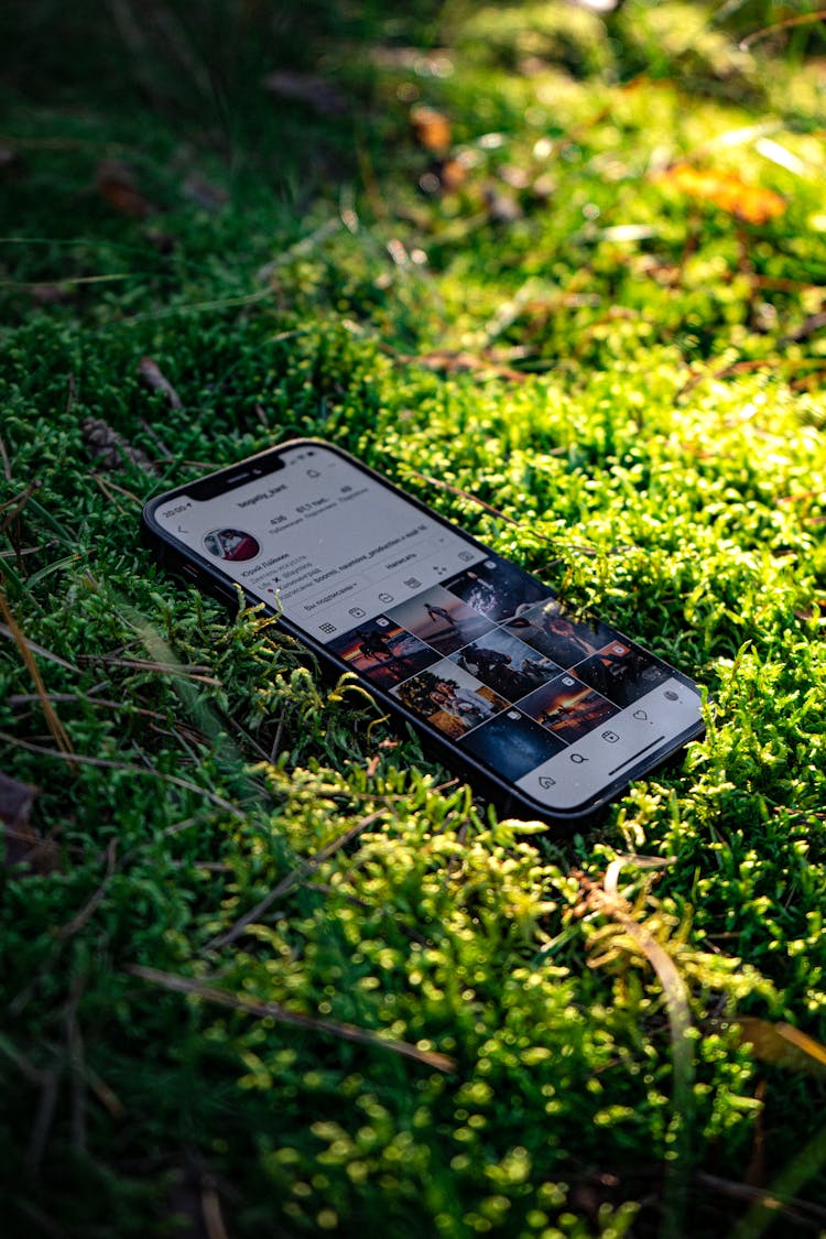 Smart Phone On Moss In Forest