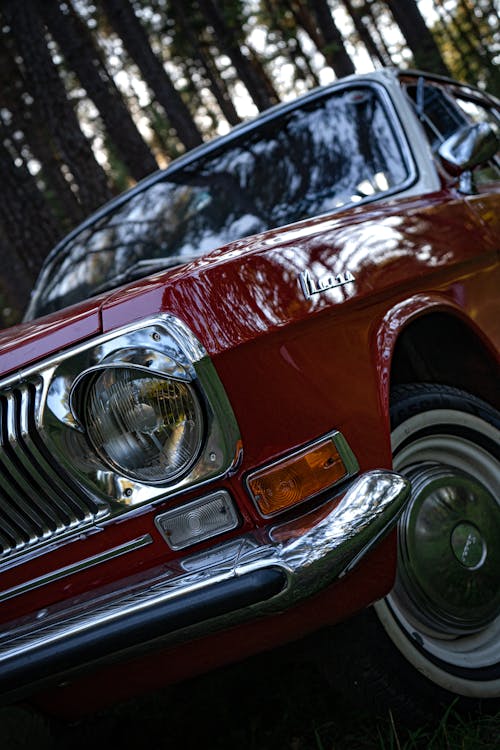 Free A Headlight and Stainless Bumper of a Classic Red Car Stock Photo
