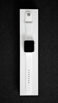 White smartwatch showcased in a minimalist style on black background, emphasizing modern design.