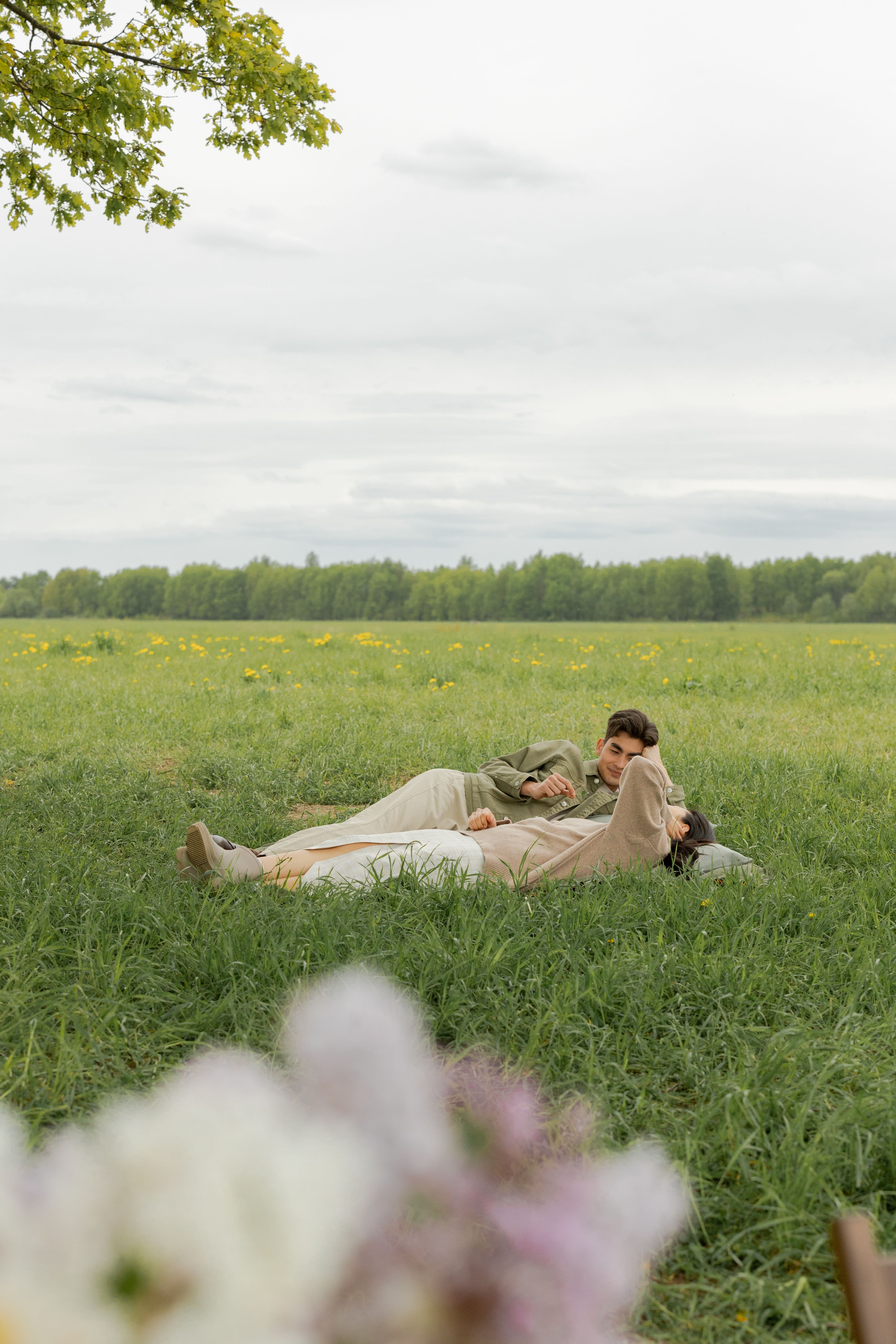 Man and Woman Lying on Green Grass Field · Free Stock Photo