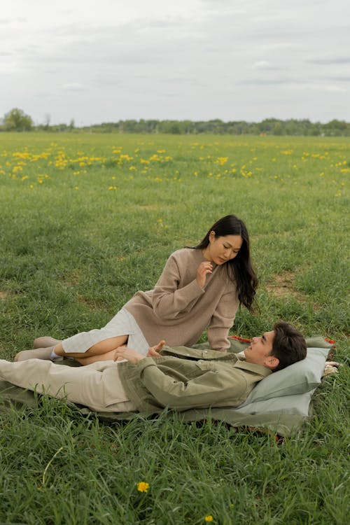 Free Couple Lying Down on Meadow Stock Photo