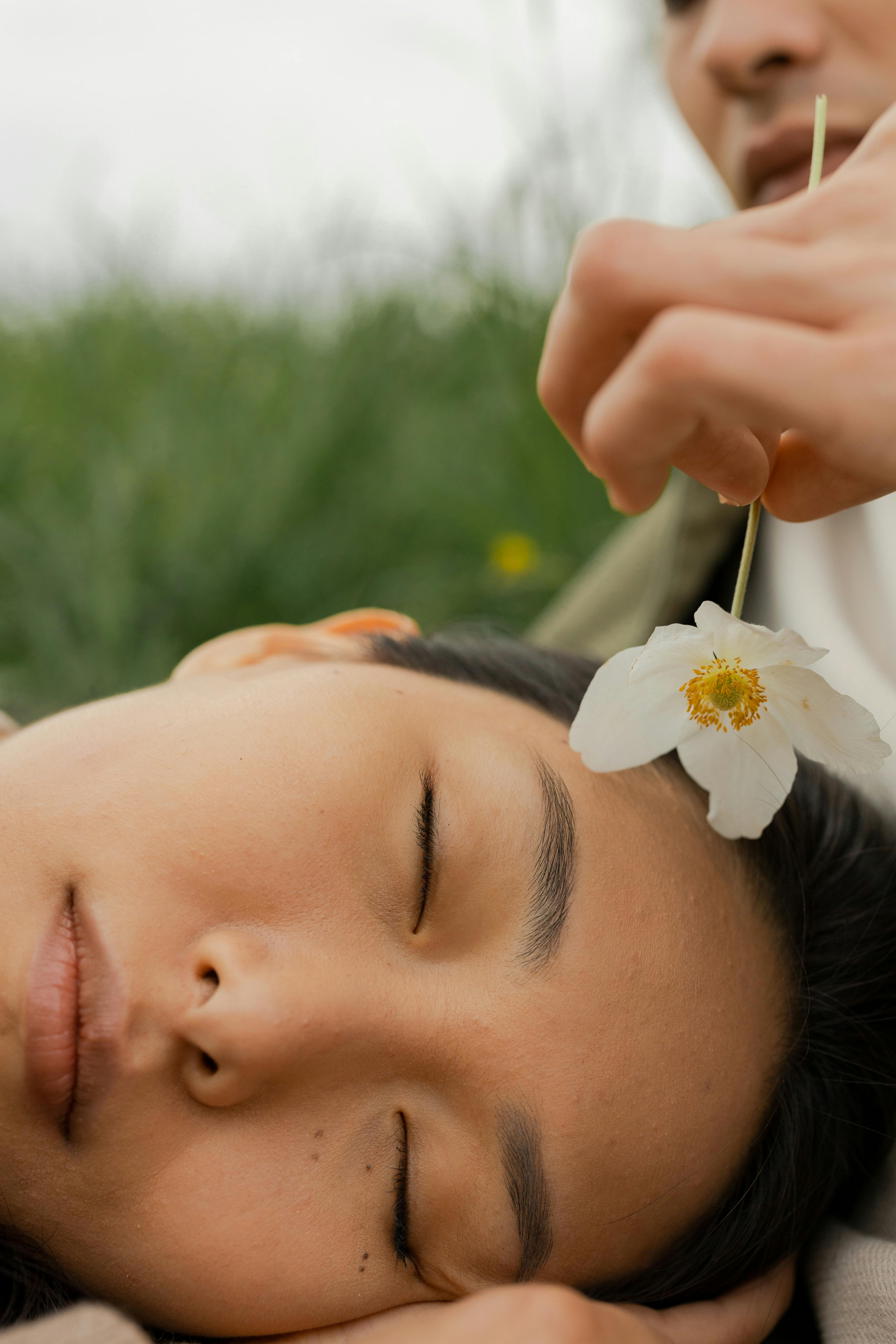 woman holding white flower