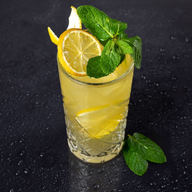 Lemon and mint drink in a tall glass — photo by Nasim Didar on Pexels