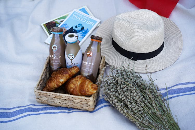 Food, Drinks, Flowers And Hat On A Picnic Blanket 