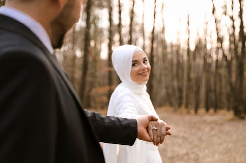 Free Couple Holding Hands in the Woods
 Stock Photo
