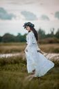 Woman in White Dress Standing on Green Grass Field