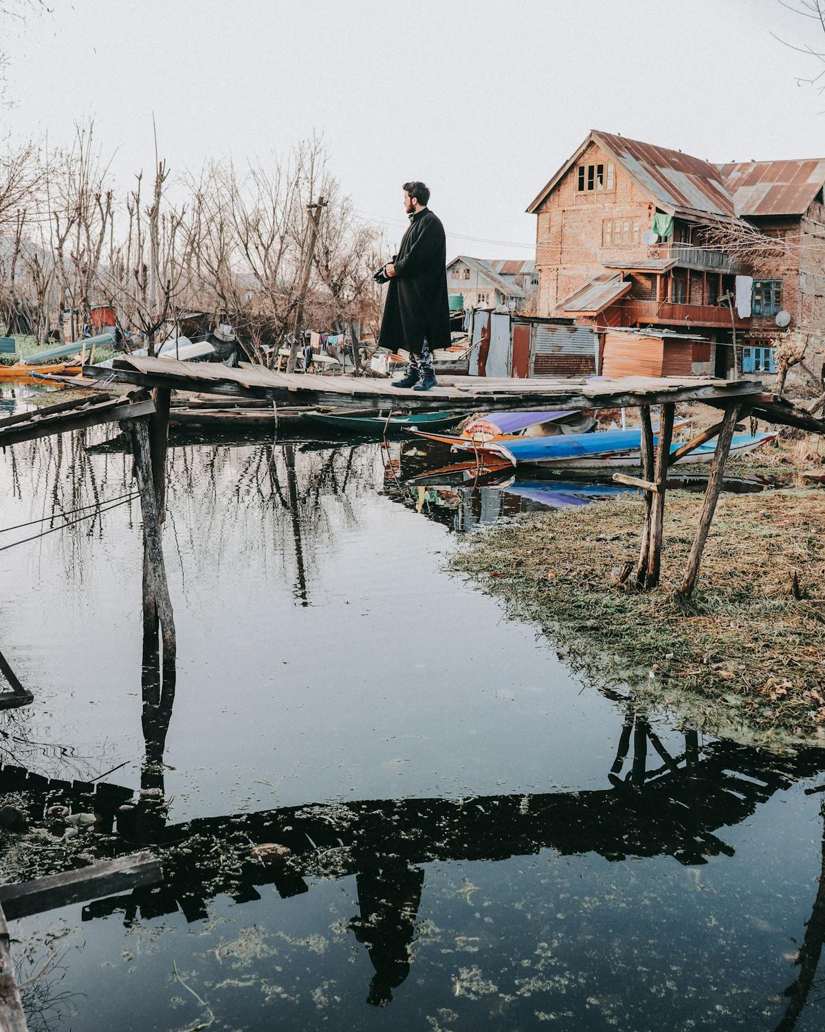 Snack plate with dips, crackers, and fresh vegetables on a coffee table next to a drink